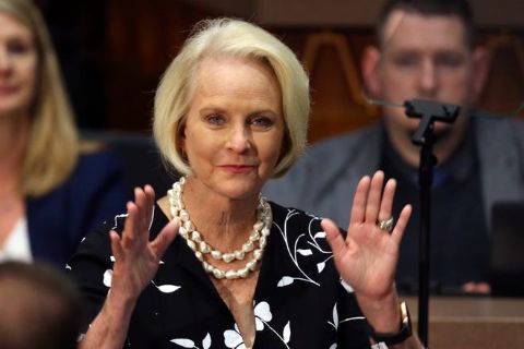 Cindy McCain in a black coat poses a picture.